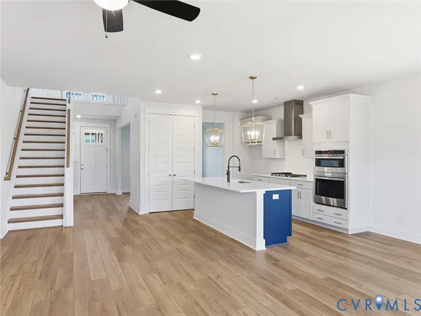 a kitchen with stainless steel appliances granite countertop a sink stove and a refrigerator