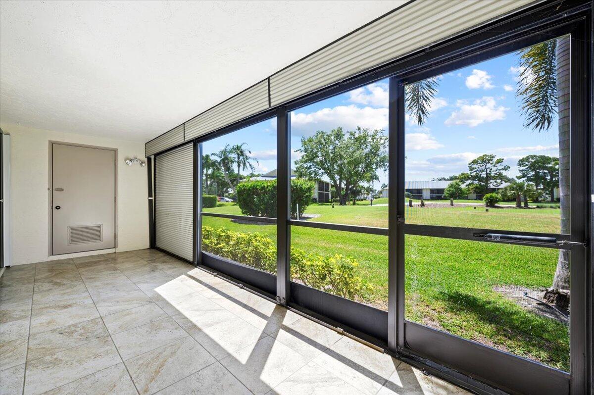 101 Pinecrest Circle, Unit A Jupiter, FL 33458 - Photo 19 of 25 a view of a room with a large window and an outdoor view
