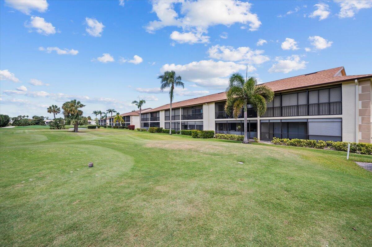 101 Pinecrest Circle, Unit A Jupiter, FL 33458 - Photo 20 of 25 a view of a house with a big yard and large tree
