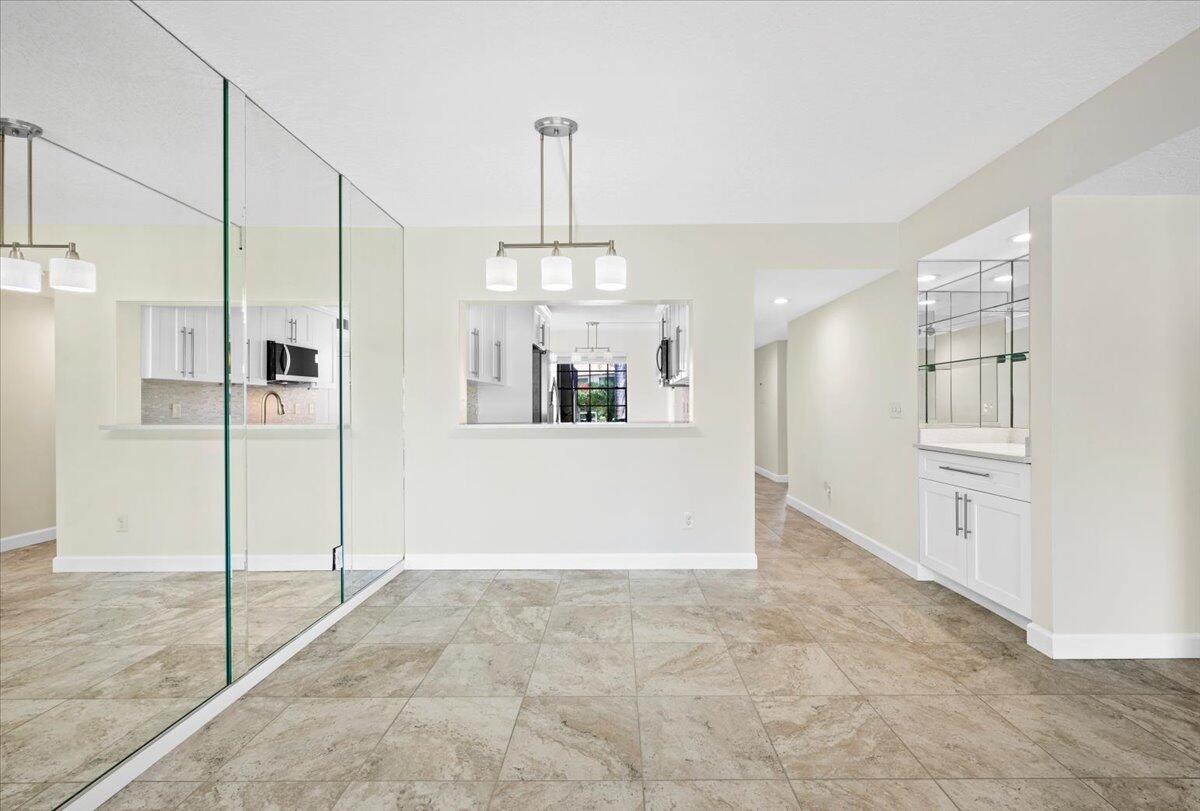 101 Pinecrest Circle, Unit A Jupiter, FL 33458 - Photo 6 of 25 a view of a kitchen with a sink and refrigerator