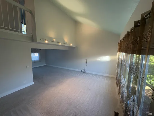 an empty room with a empty space and windows