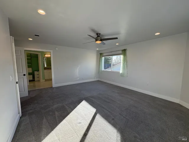 a spacious bathroom with a granite countertop sink and a mirror