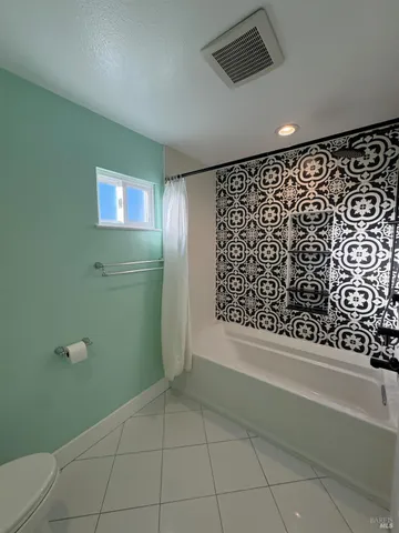 a view of an empty room with a bathroom