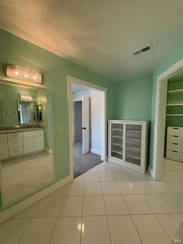 an empty room with large windows and city view