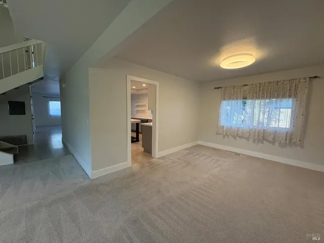 a kitchen with furniture and a wooden floor