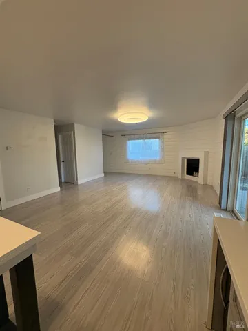 a room with pool table and wooden floor