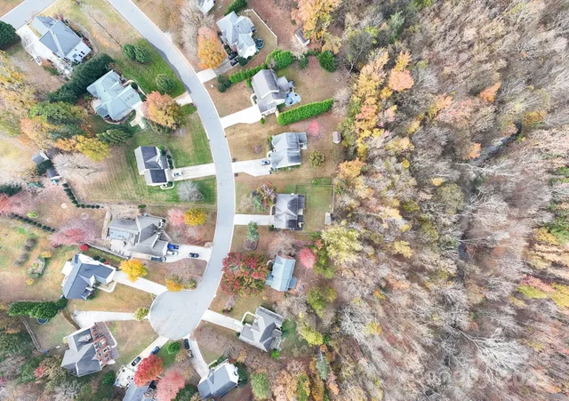 aerial view of a house with garden space and sitting area