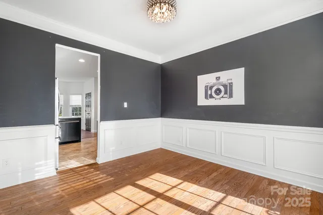 a dining room with furniture and wooden floor