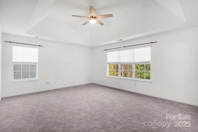 a bedroom with a bed and a dresser next to a window