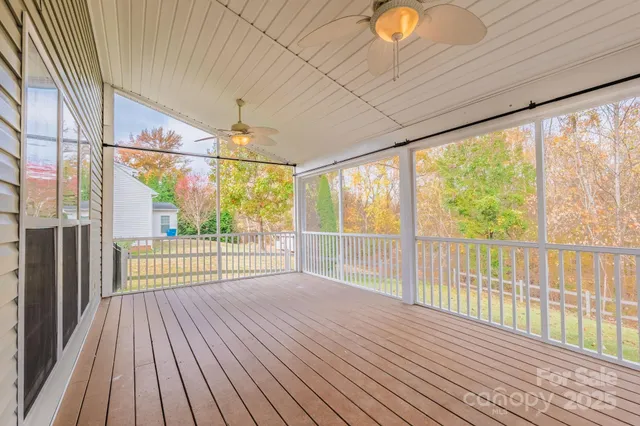 a view of a room with wooden floor and iron stairs