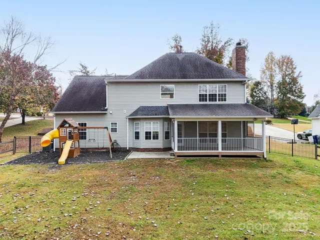 a view of a house with a yard and sitting area