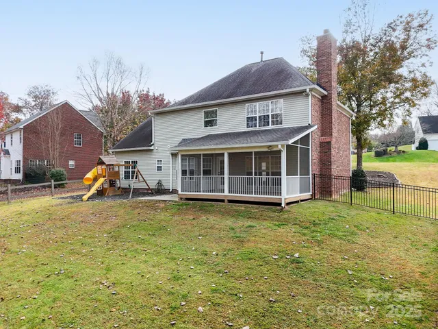 a view of a house with a yard and sitting area