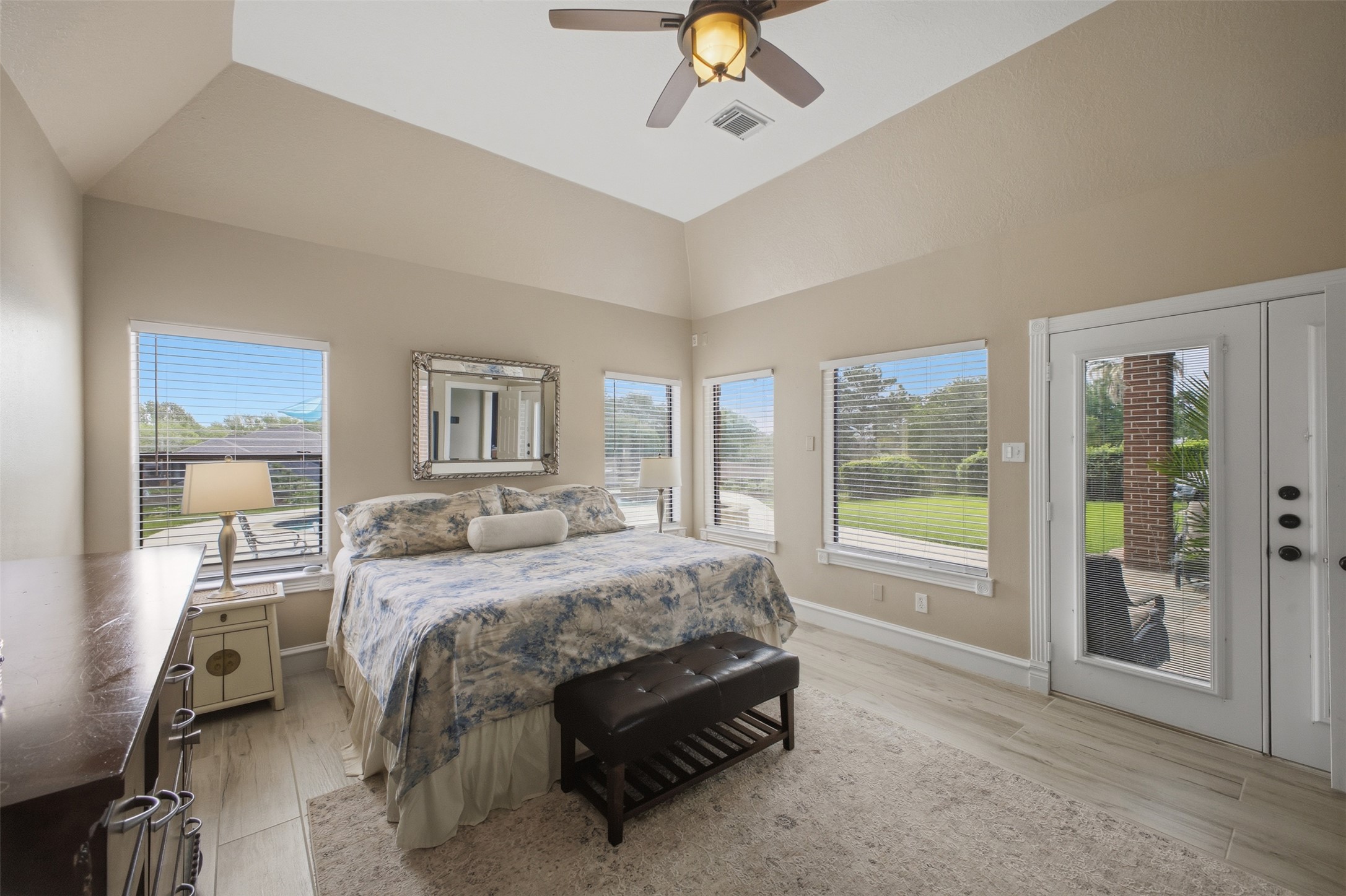 12710 Aries Loop Willis, TX 77318 - Photo 19 of 40 This inviting room features vaulted ceilings, light-colored walls, and a ceiling fan with an integrated light fixture