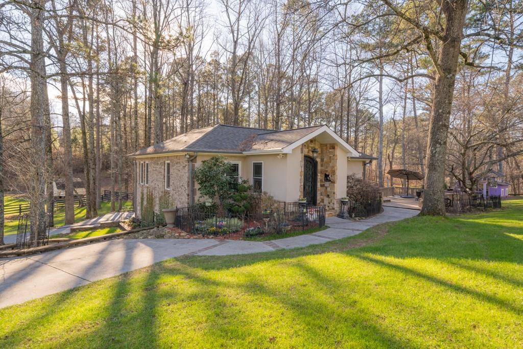 16560 Freemanville Road Alpharetta, GA 30004 - Photo 1 of 1 a front view of a house with swimming pool and sitting area