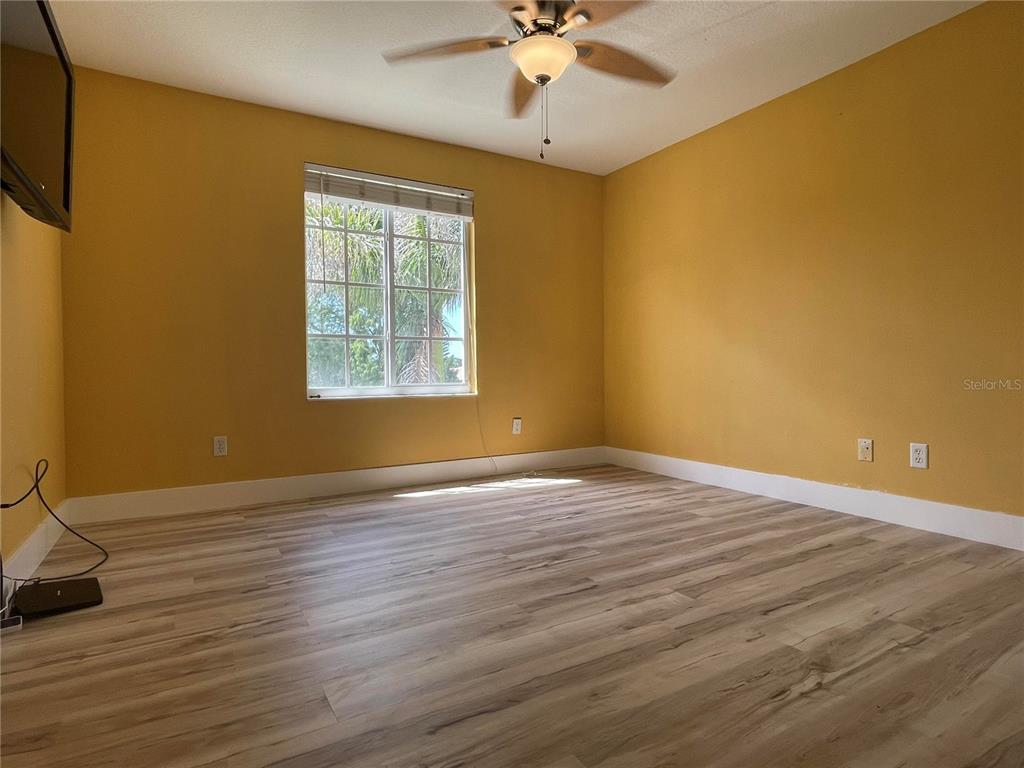 759 Fordingbridge Way Osprey, FL 34229 - Photo 7 of 51 a view of an empty room with wooden floor and a window