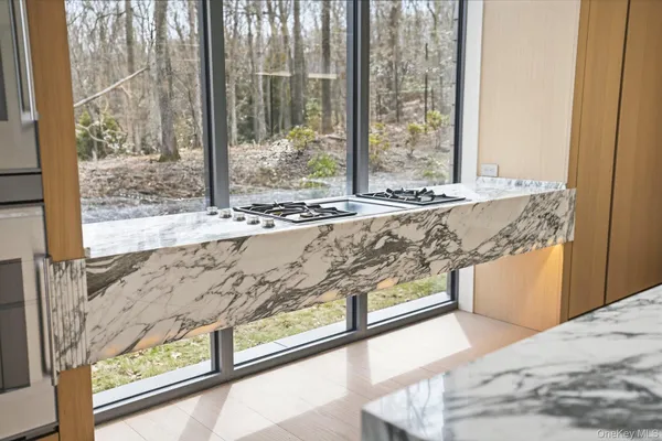 a view of a kitchen with kitchen island and windows