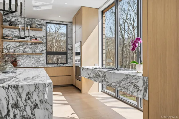 a bathroom with a granite countertop tub a sink and a large mirror next to it