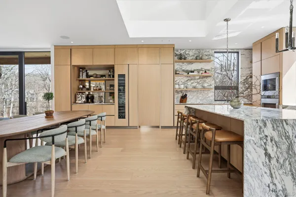 a kitchen with stainless steel appliances a dining table chairs and granite counter tops