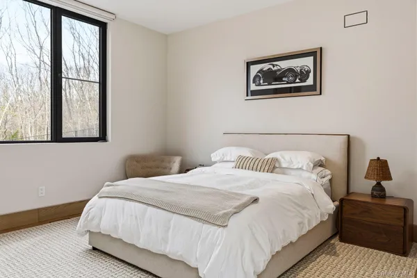 a bedroom with a bed and a painting on the wall