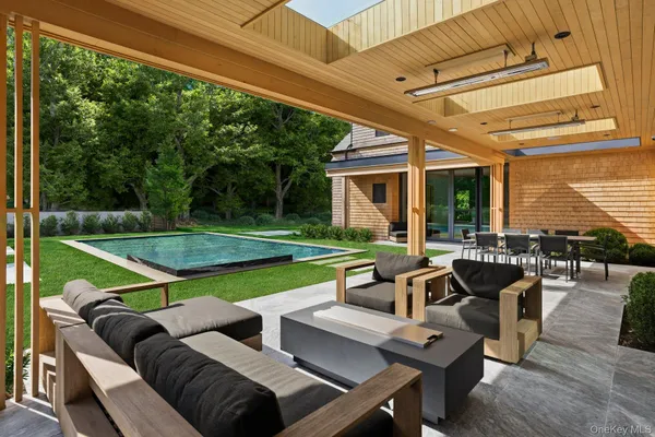 a view of a patio with couches table chairs and floor to ceiling window