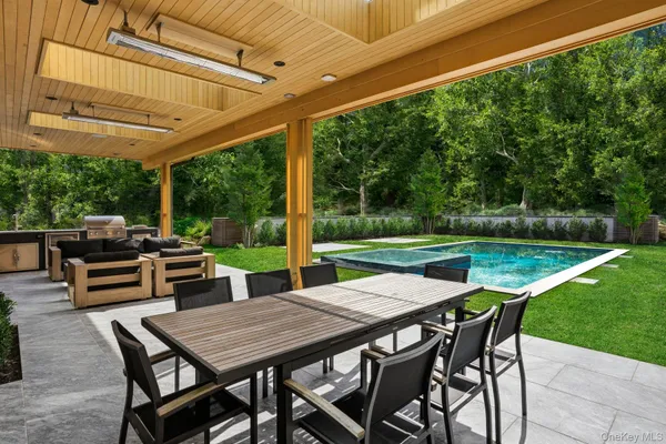 a view of a patio with a table chairs and a backyard