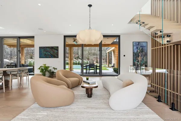 a living room with furniture and a chandelier