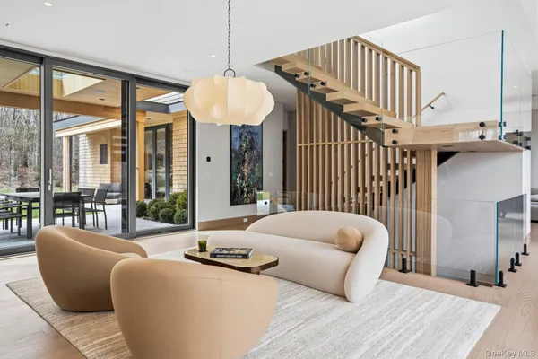 a living room with furniture and a chandelier