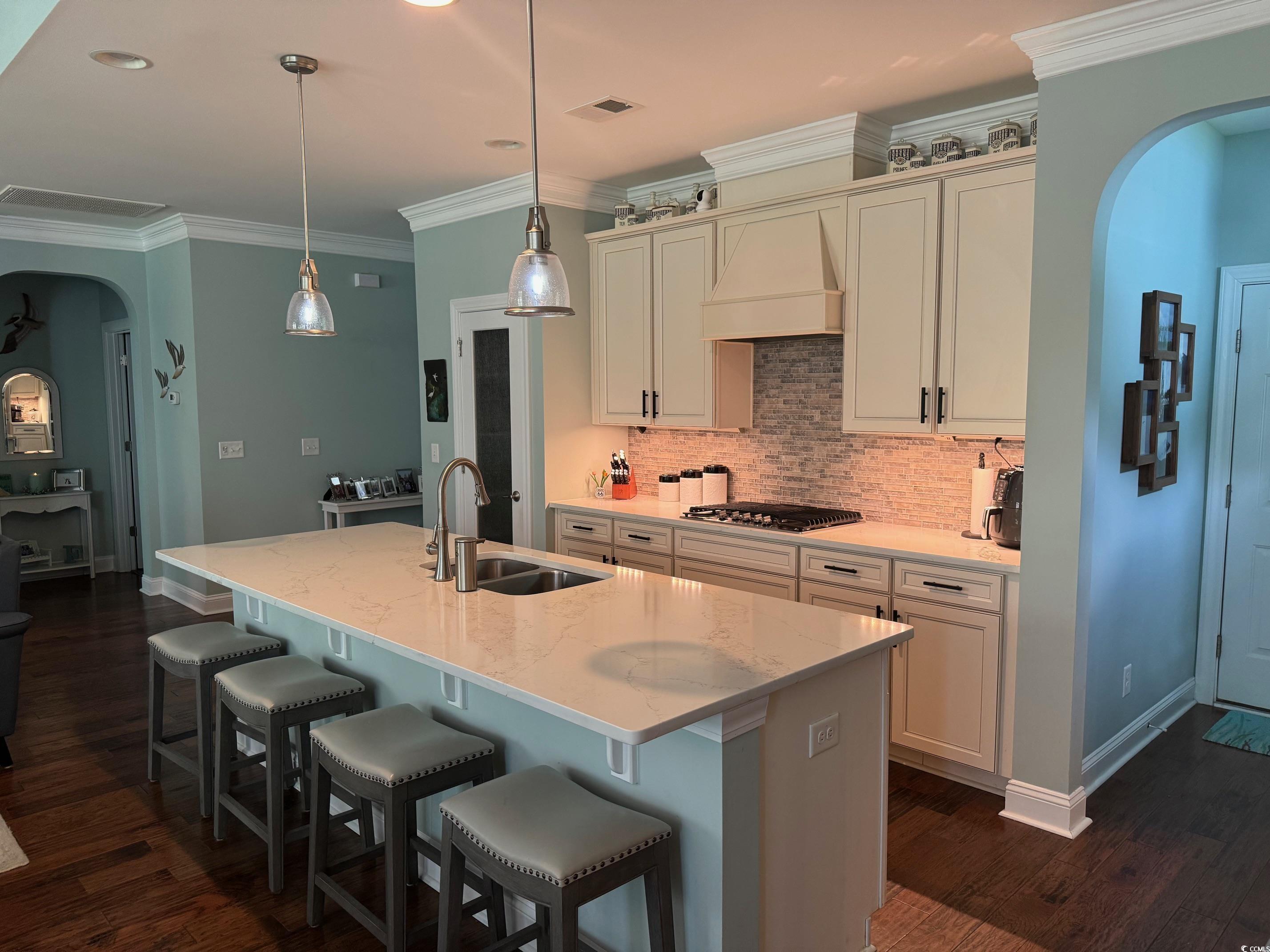 1592 Buckingham Avenue Myrtle Beach, SC 29577 - Photo 4 of 37 Kitchen with custom range hood, dark hardwood / wo