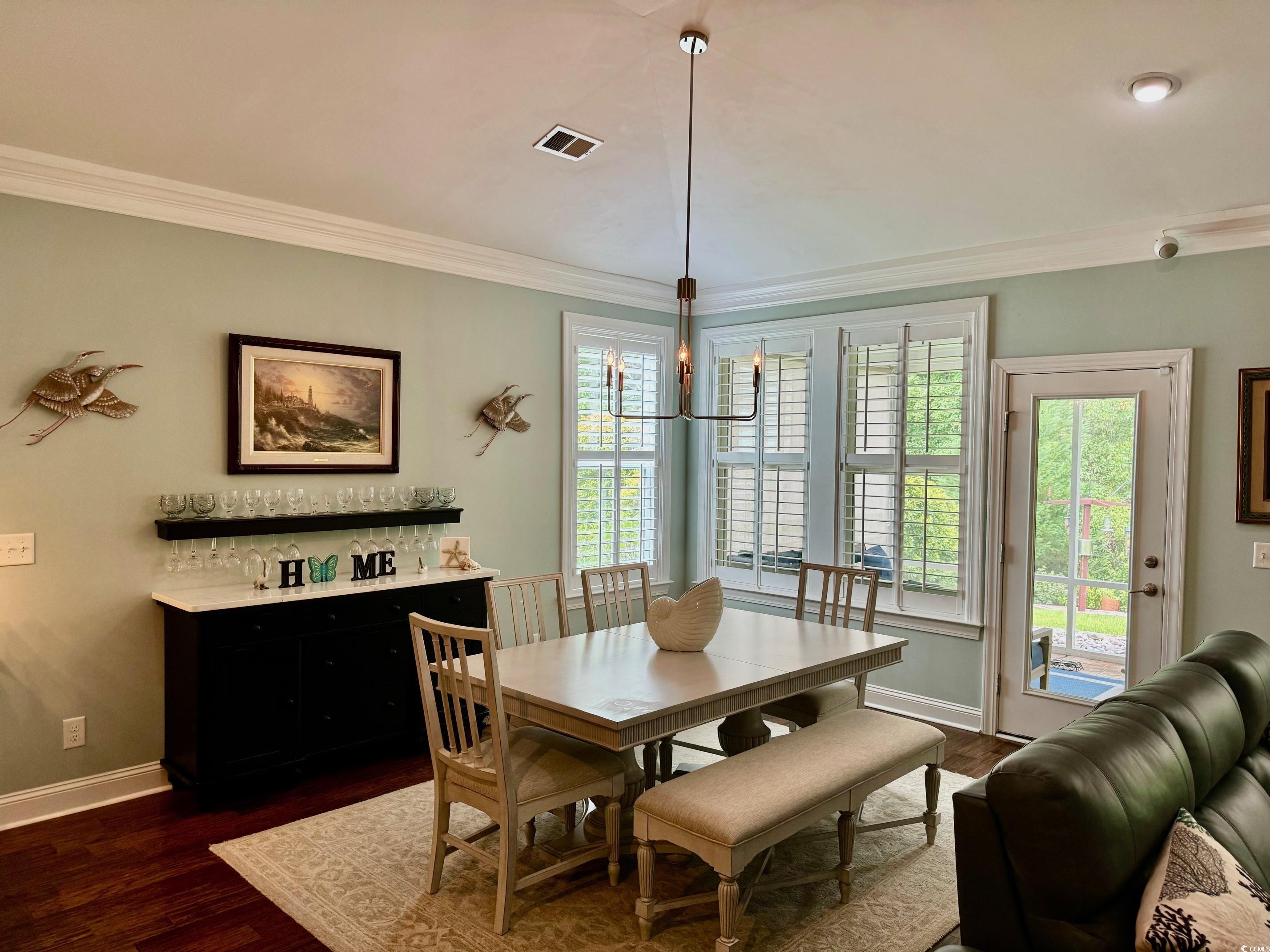 1592 Buckingham Avenue Myrtle Beach, SC 29577 - Photo 8 of 37 Dining space with crown molding and dark wood-type