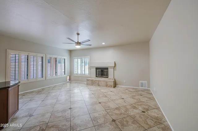 a kitchen with granite countertop a refrigerator and a stove top oven
