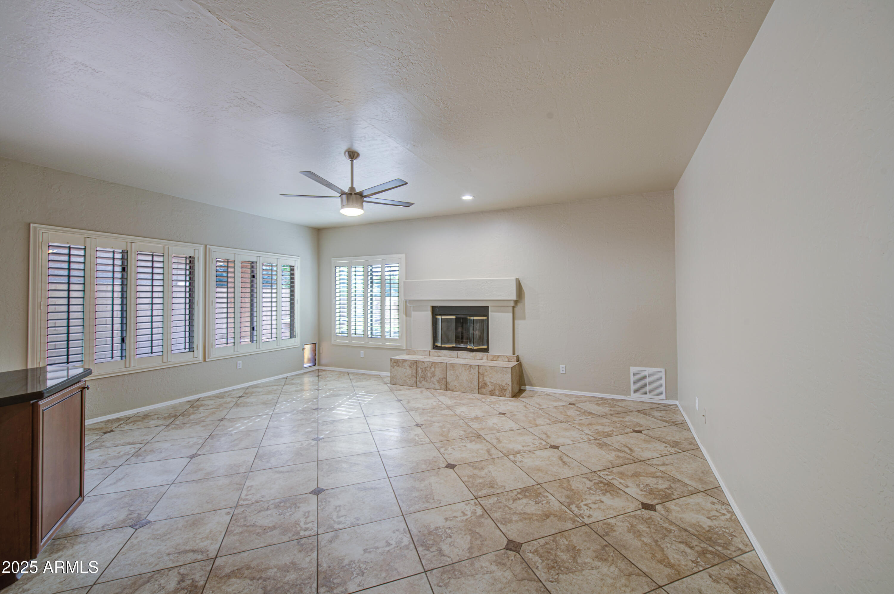16237 South 13th Street Phoenix, AZ 85048 - Photo 27 of 68 a view of an empty room with a fireplace and a window