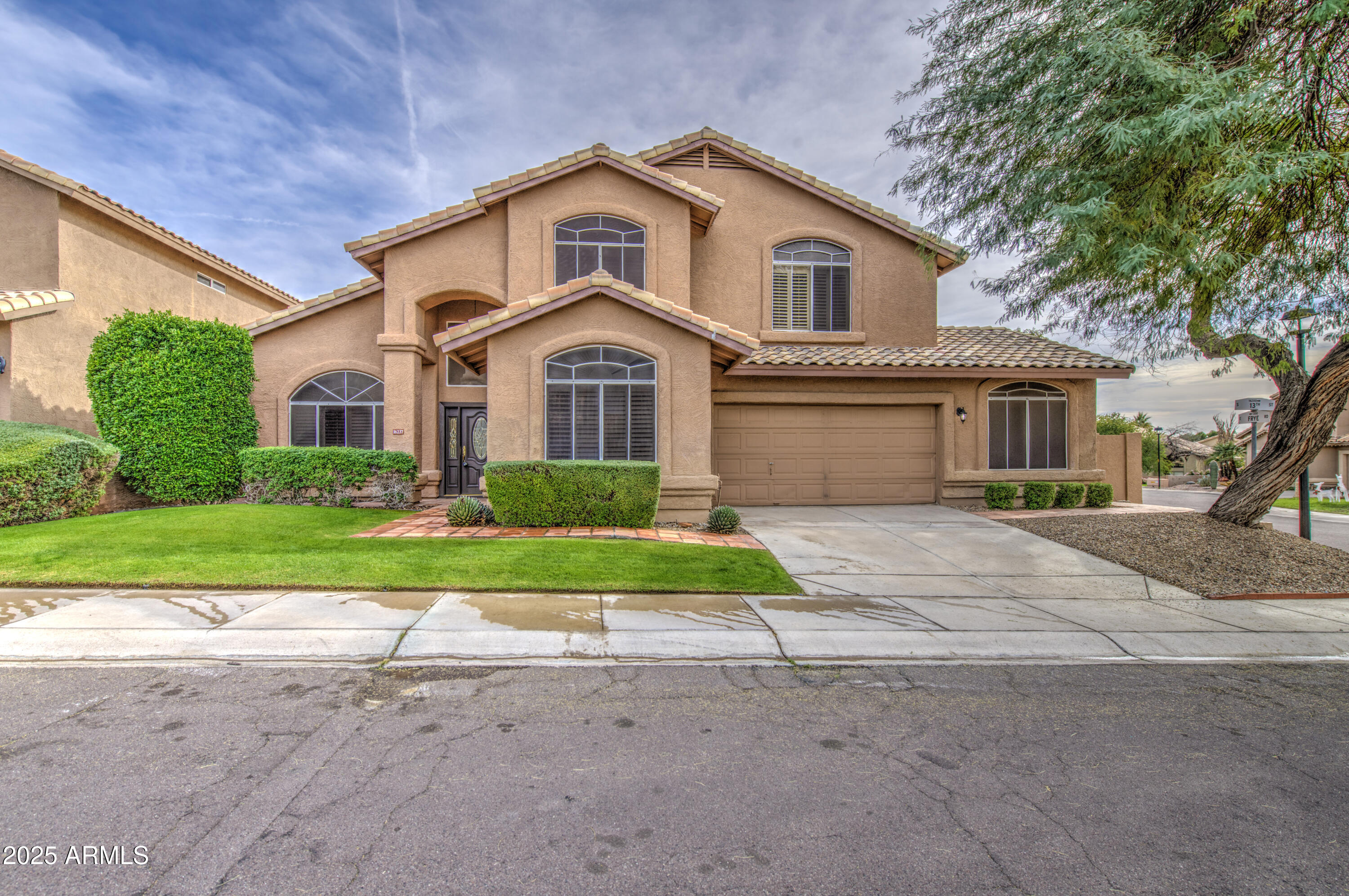 16237 South 13th Street Phoenix, AZ 85048 - Photo 3 of 68 a front view of a house with a yard and garage