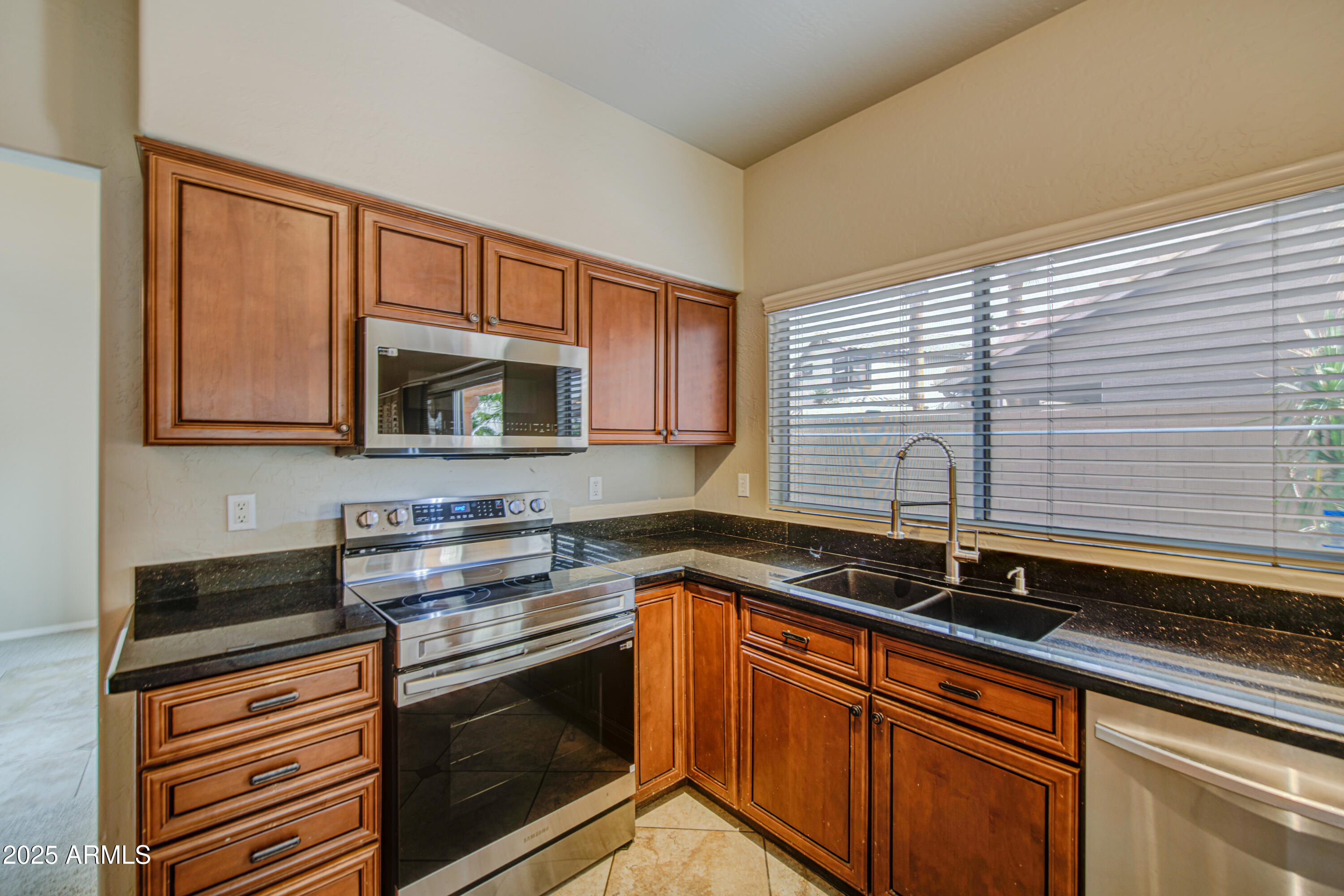 16237 South 13th Street Phoenix, AZ 85048 - Photo 31 of 68 a kitchen with stainless steel appliances granite countertop a sink stove and microwave