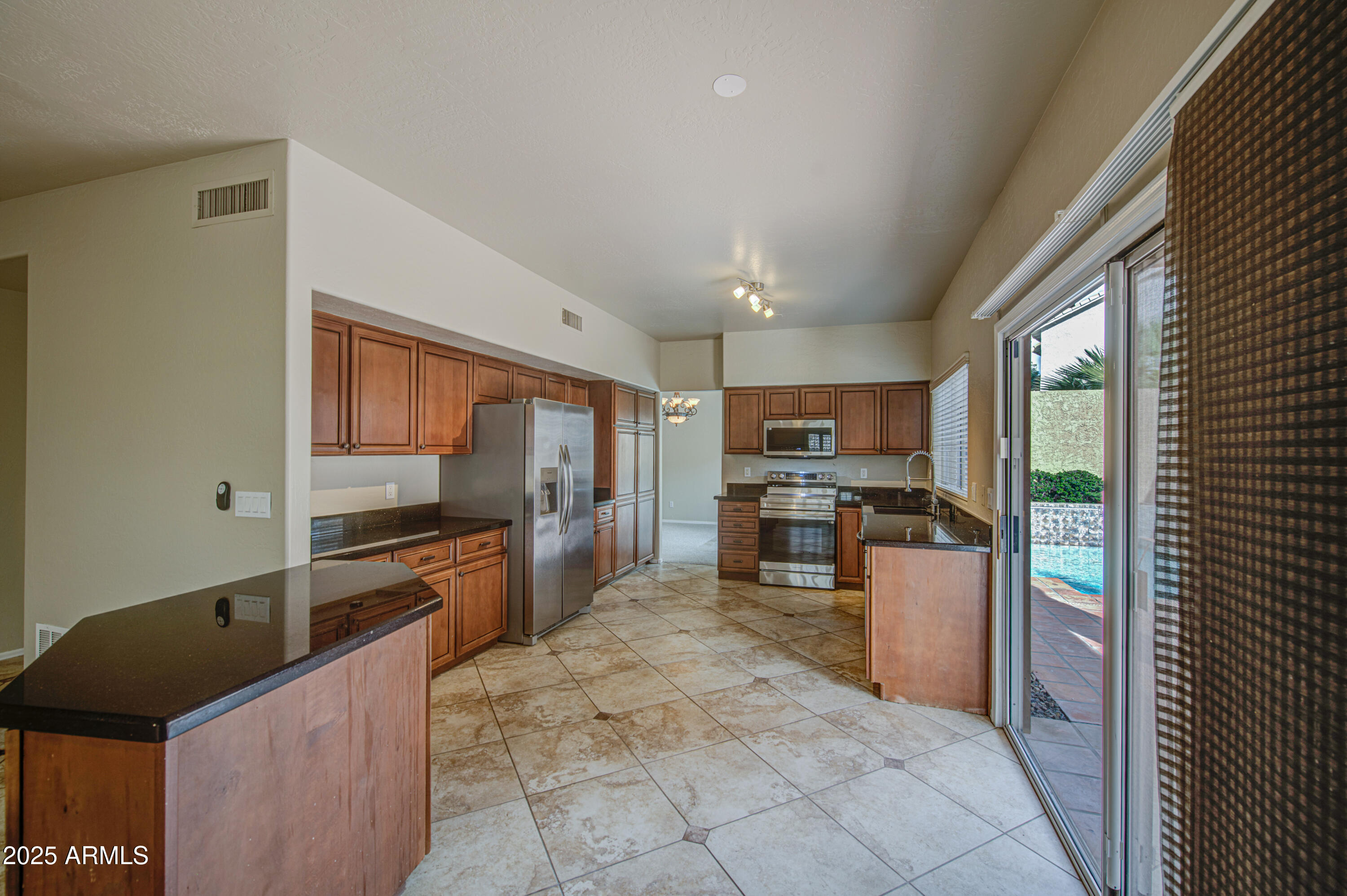 16237 South 13th Street Phoenix, AZ 85048 - Photo 33 of 68 a kitchen with granite countertop a refrigerator and a stove top oven