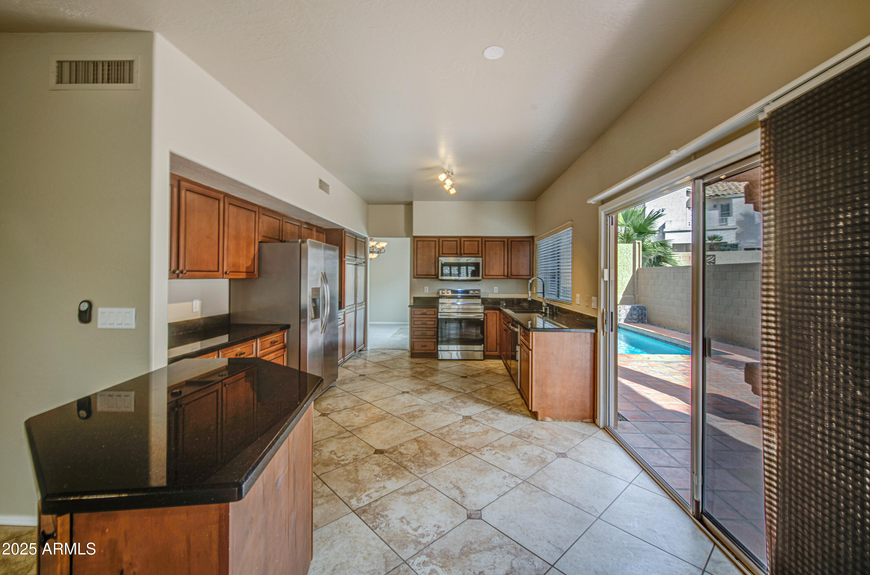 16237 South 13th Street Phoenix, AZ 85048 - Photo 34 of 68 a kitchen with stainless steel appliances granite countertop a refrigerator and a stove top oven
