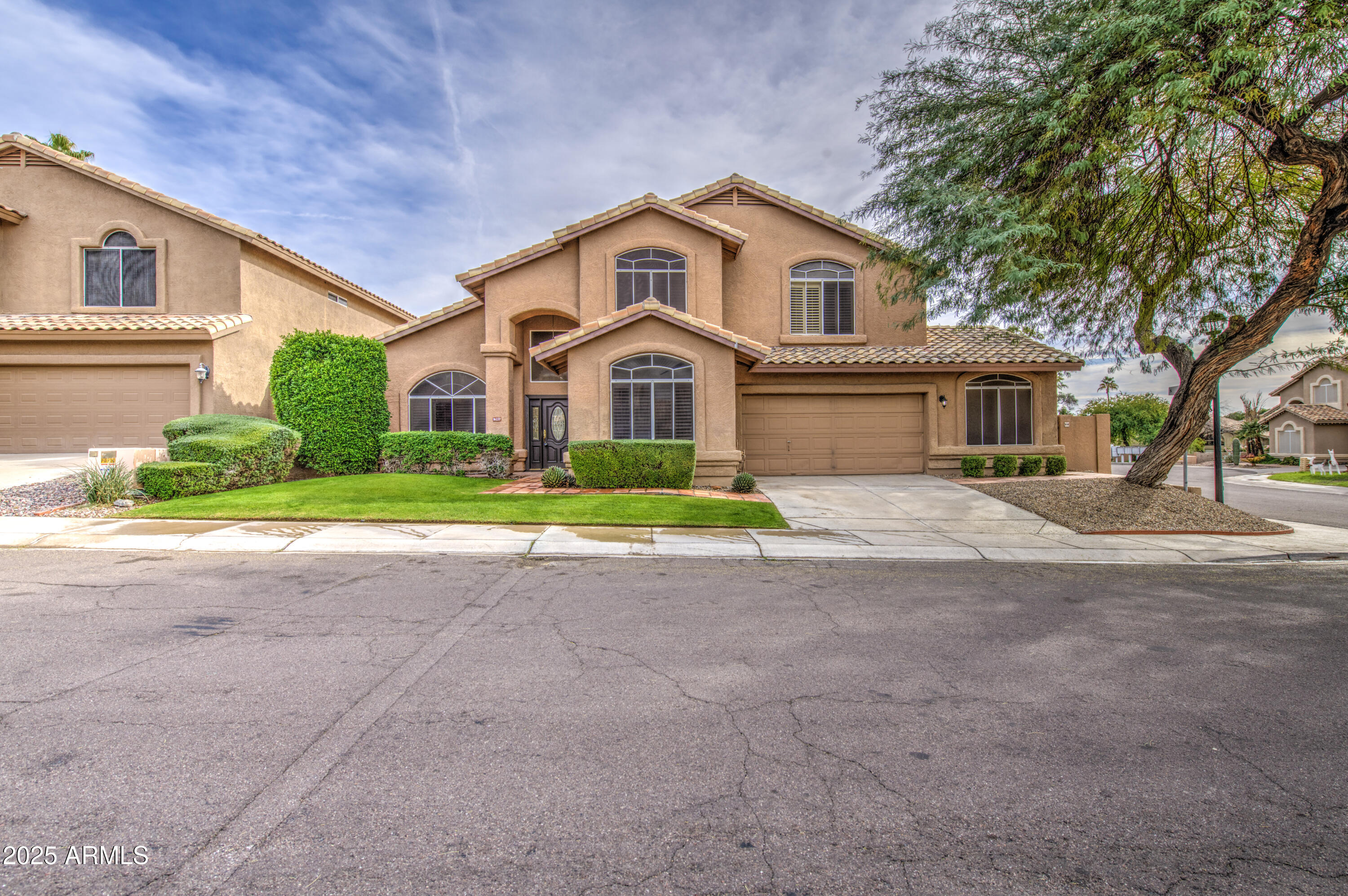 16237 South 13th Street Phoenix, AZ 85048 - Photo 4 of 68 a front view of a house with a garden and trees