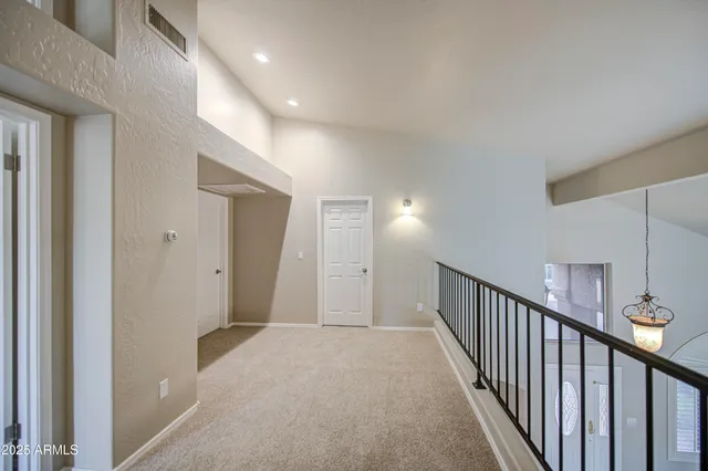 a view of a livingroom with a ceiling fan and a chandelier fan