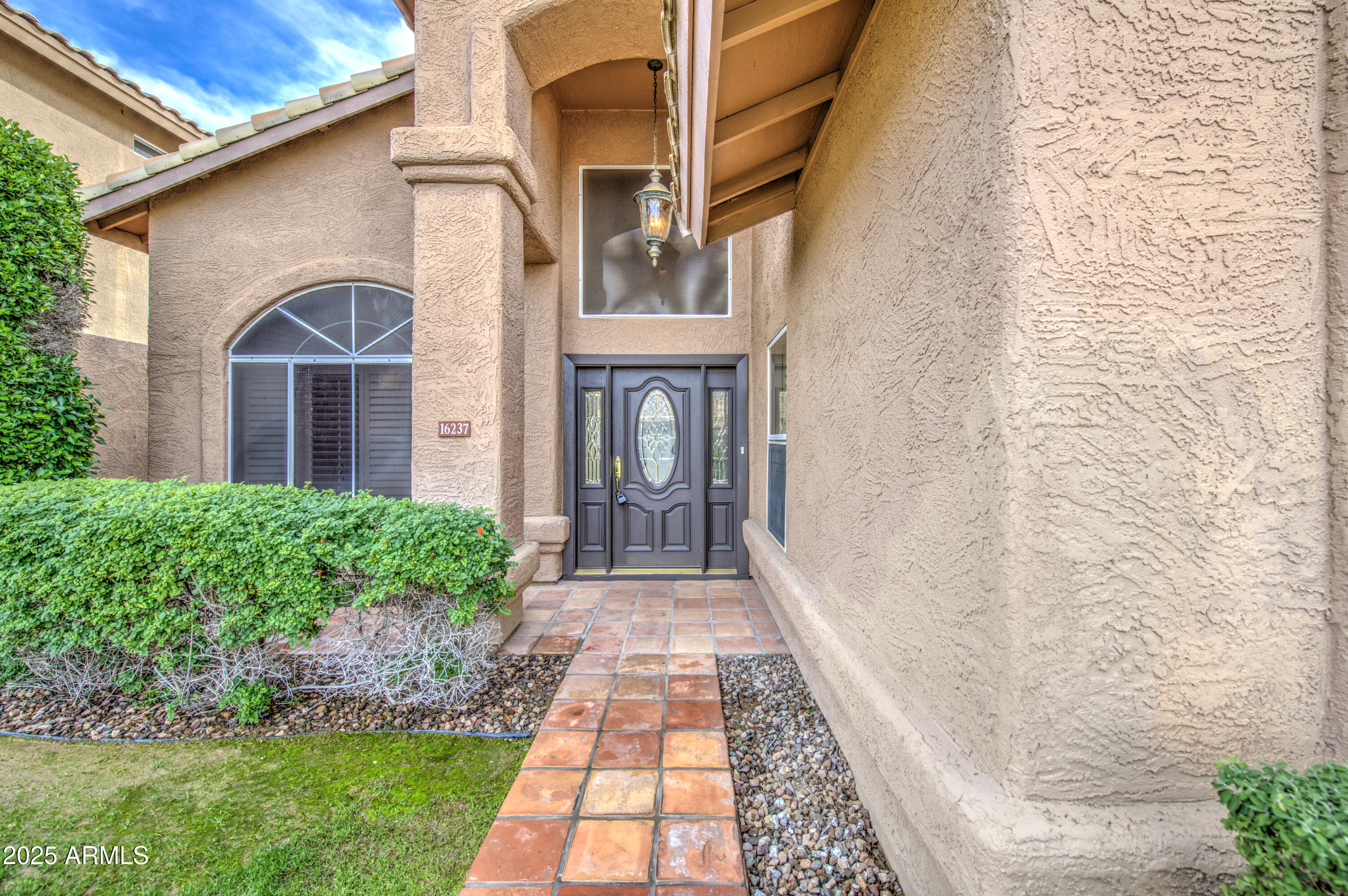 16237 South 13th Street Phoenix, AZ 85048 - Photo 6 of 68 a view of a brick house with a yard