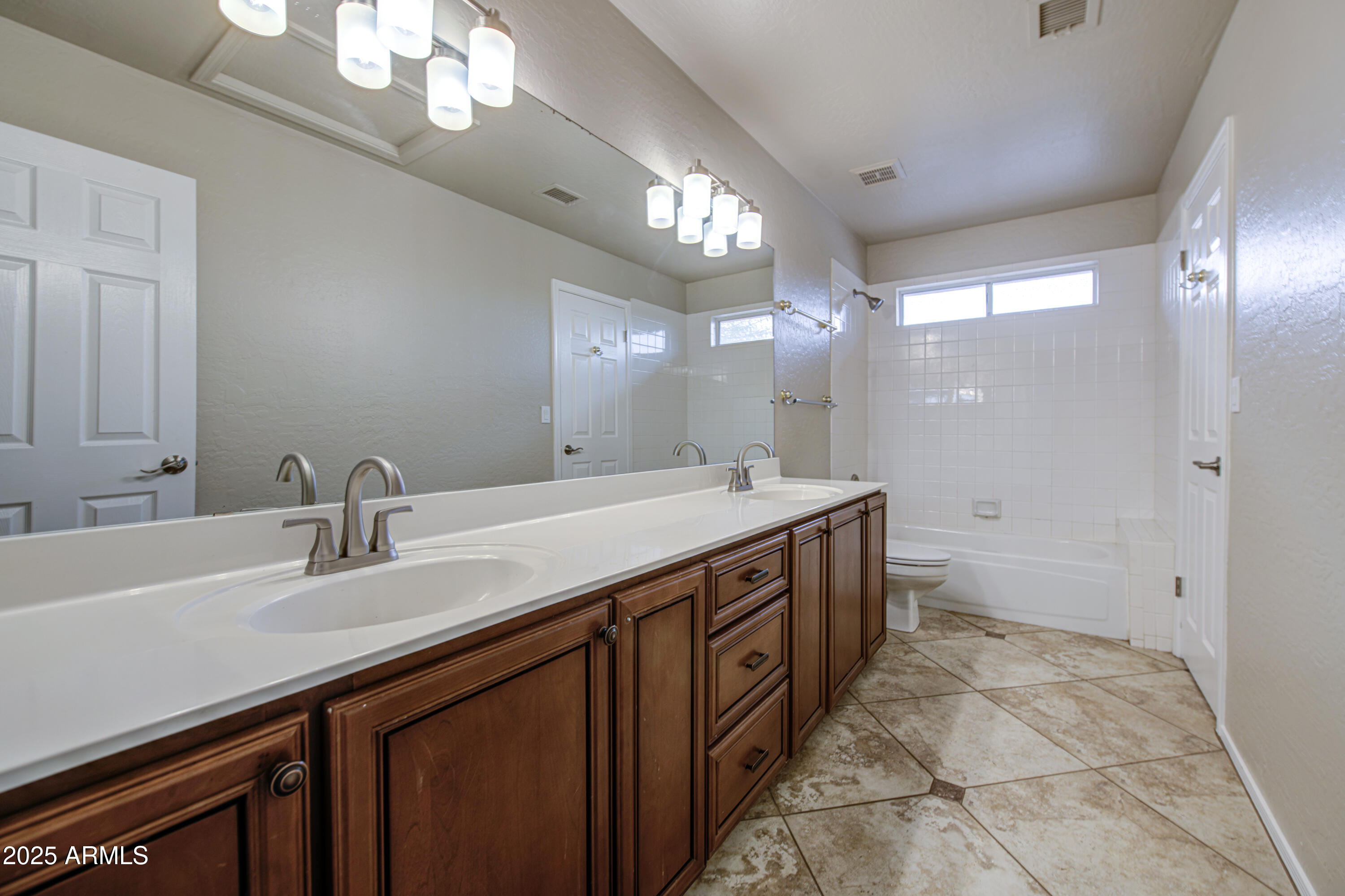 16237 South 13th Street Phoenix, AZ 85048 - Photo 10 of 68 a spacious bathroom with a double vanity sink a mirror and a shower