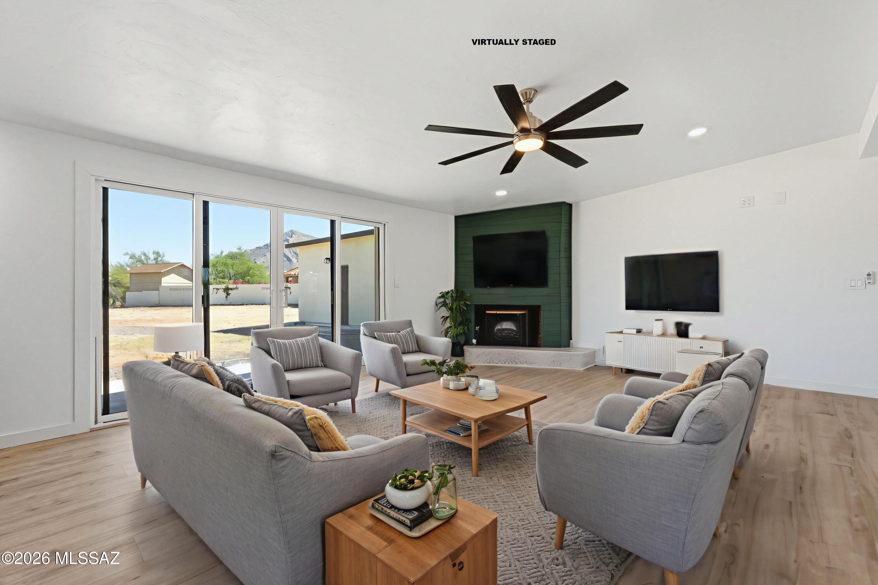 950 West Ina Road Tucson, AZ 85704 - Photo 3 of 54 a living room with furniture a flat screen tv and a large window