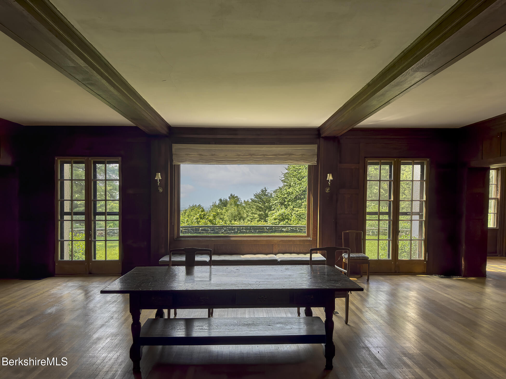 319 Under Mountain Road Lenox, MA 01240 - Photo 11 of 57 a view of a room with a large window and wooden floor
