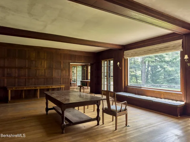 a view of a dining room with furniture and window