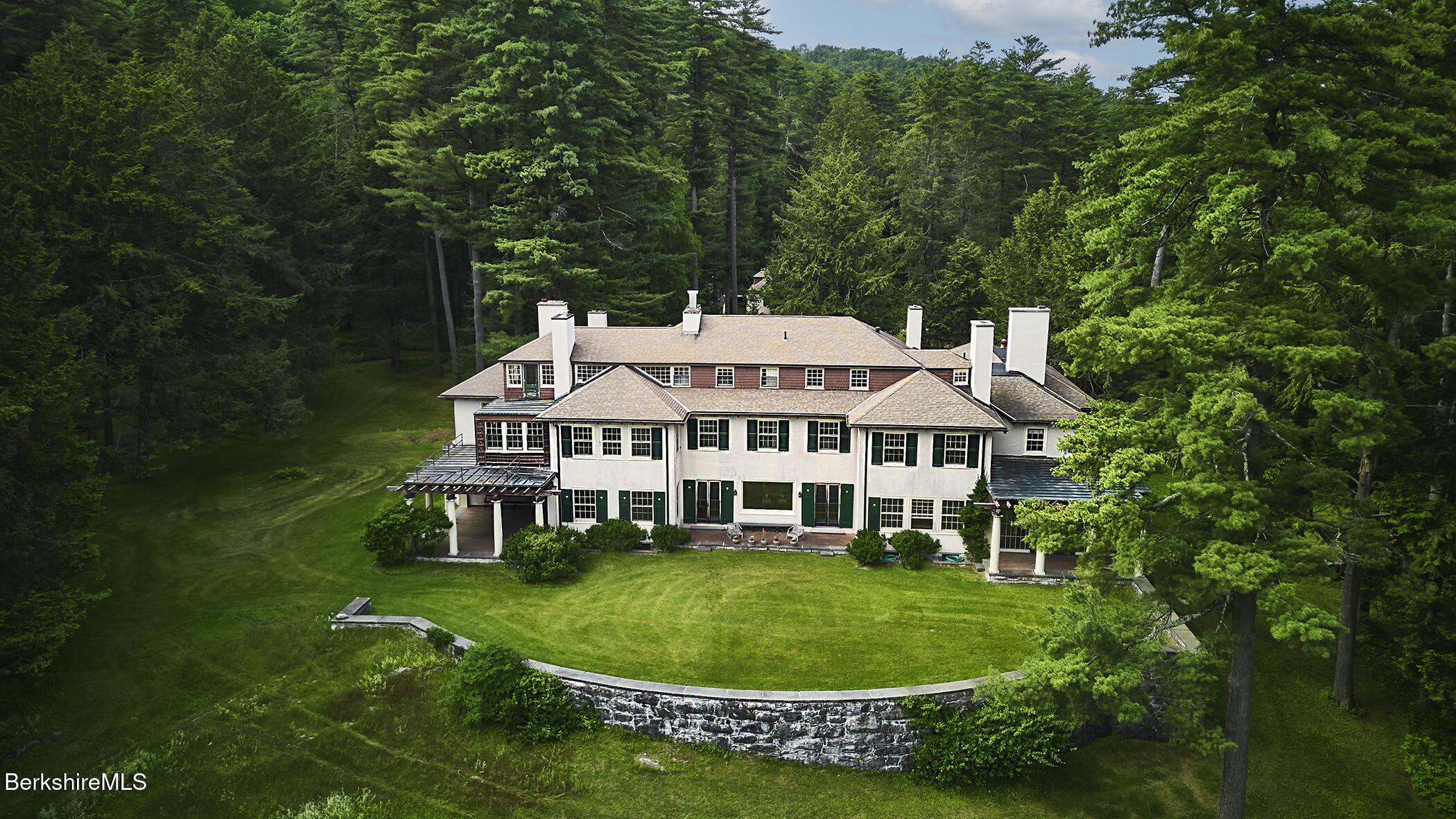319 Under Mountain Road Lenox, MA 01240 - Photo 2 of 57 a view of a white house with a sink and garden