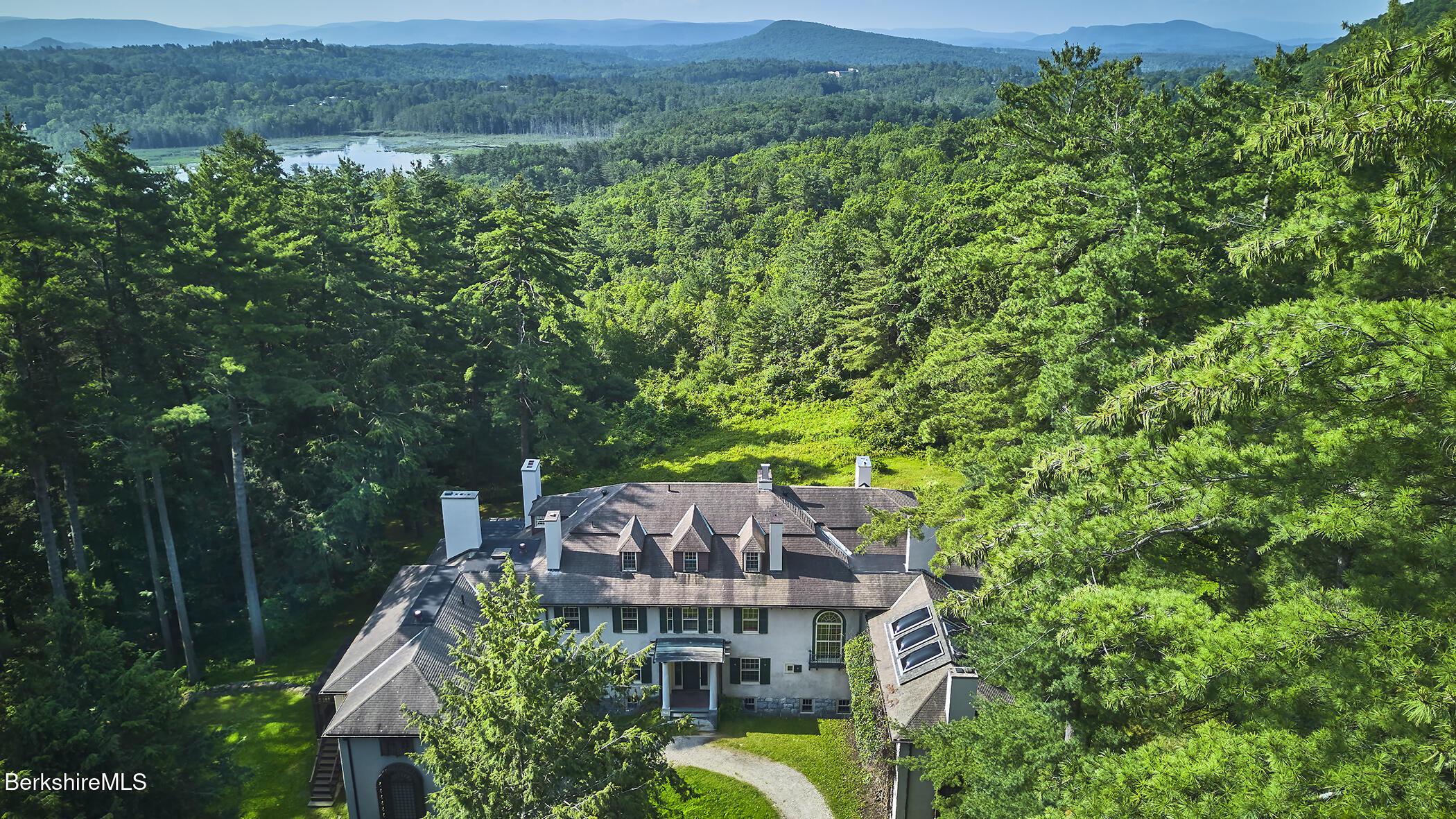 319 Under Mountain Road Lenox, MA 01240 - Photo 27 of 57 a view of a big yard with potted plants and large trees