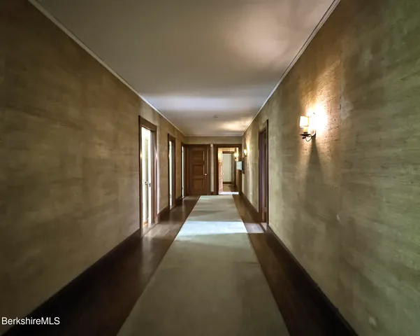 a view of hallway with wooden floor