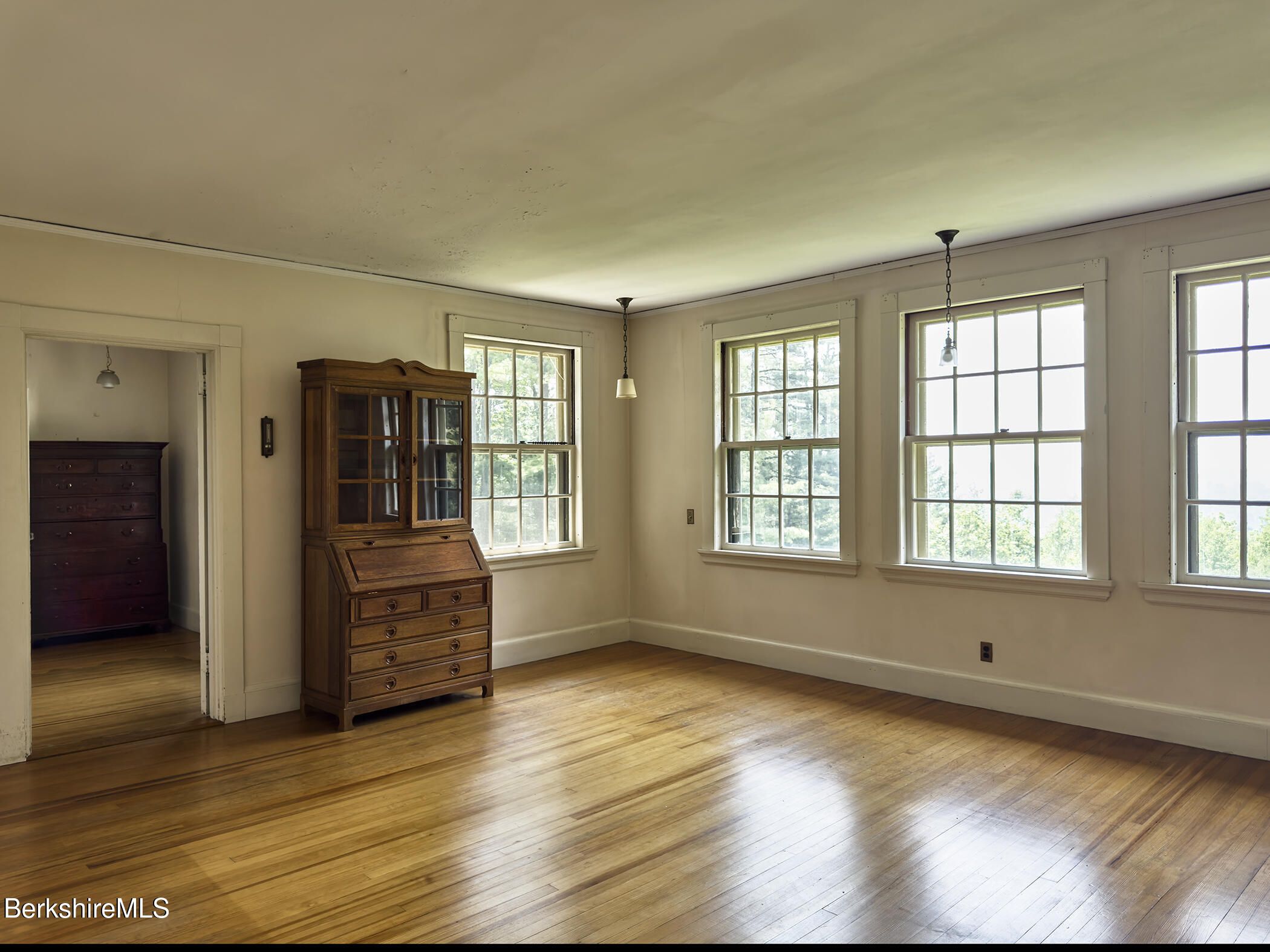 319 Under Mountain Road Lenox, MA 01240 - Photo 36 of 57 an empty room with wooden floor and windows
