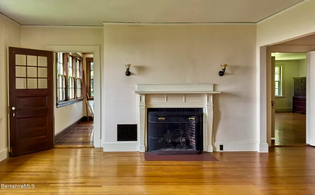 a view of a livingroom with fireplace and window