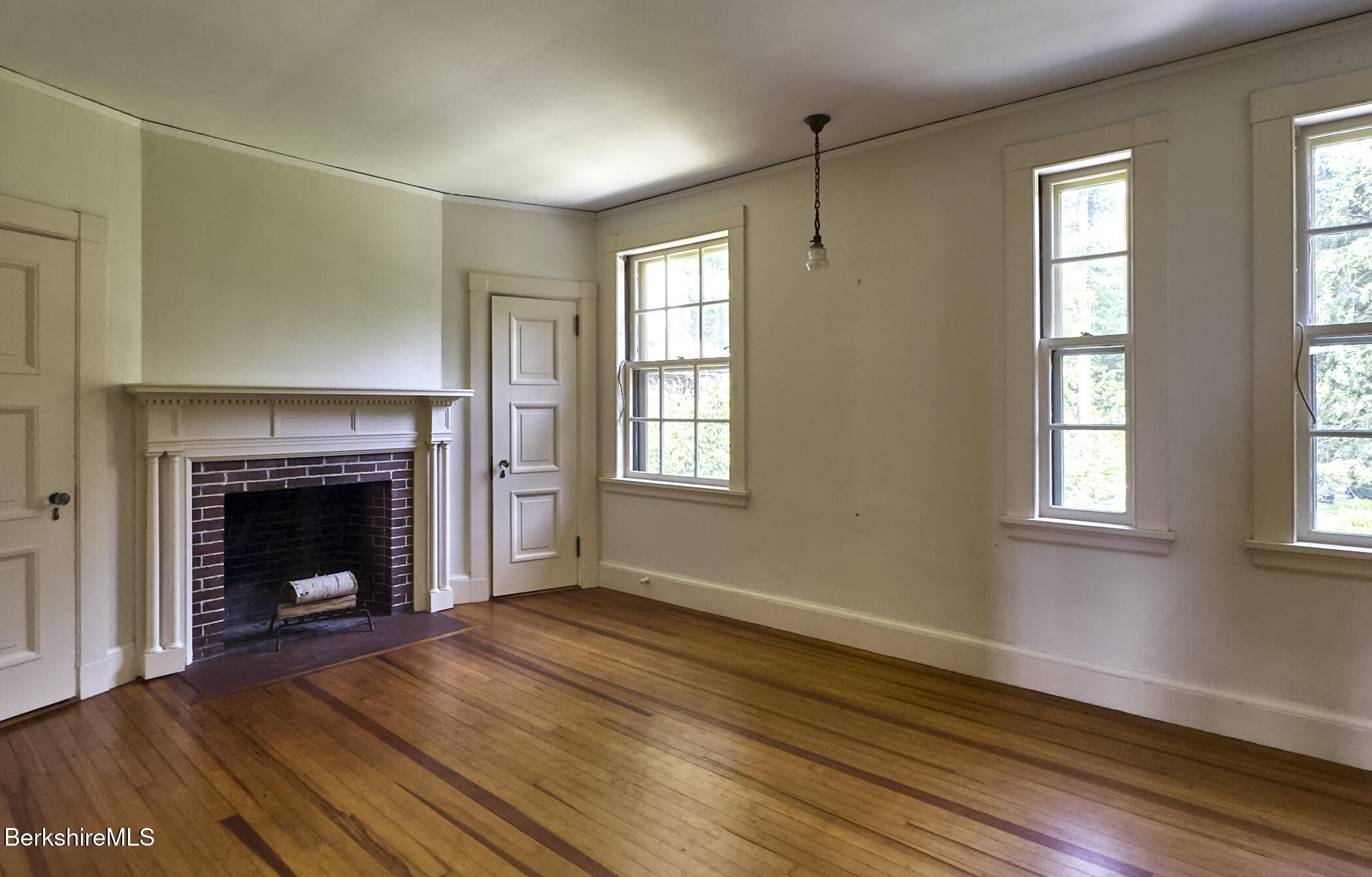 319 Under Mountain Road Lenox, MA 01240 - Photo 38 of 57 a view of an empty room with wooden floor fireplace and a window