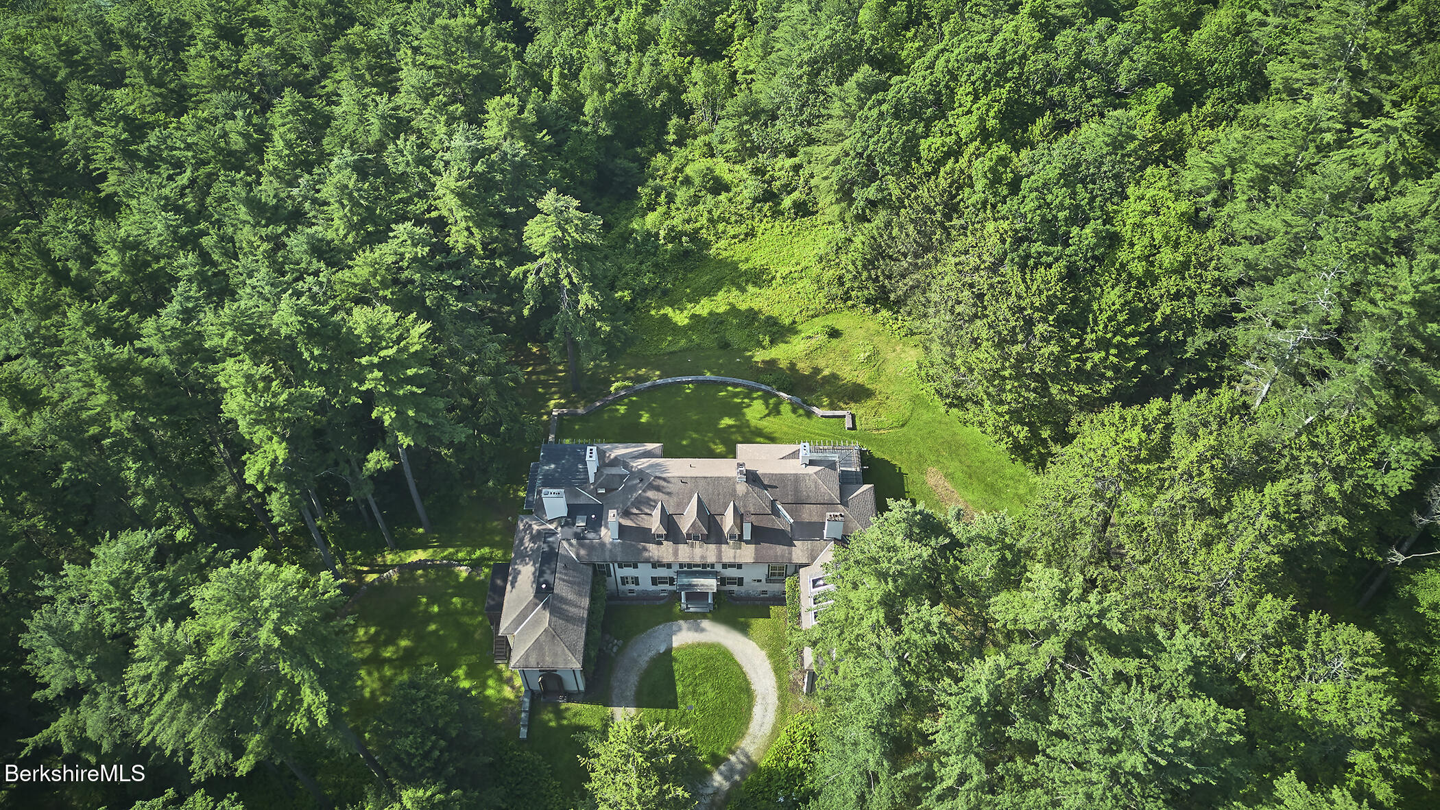 319 Under Mountain Road Lenox, MA 01240 - Photo 56 of 57 a backyard of a house with outdoor seating and green space