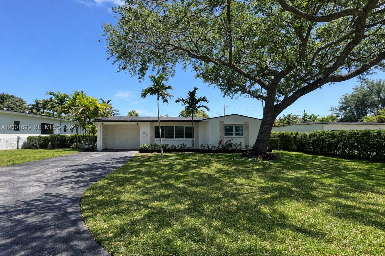 11111 Southwest 78th Court Pinecrest, FL 33156 - Photo 1 of 19 a view of a house with a tree in a yard